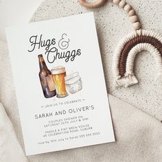 a beer themed wedding save the date card on a bed with rings and beads around it