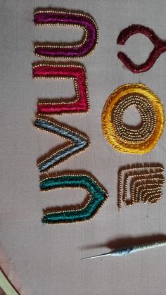 the letters are made out of beads and thread