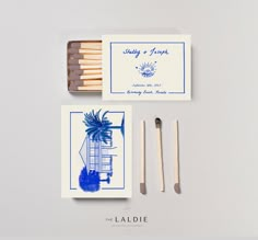 matches and matchesticks are sitting next to each other on a white surface with blue ink