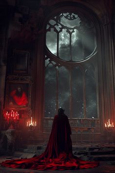 a man in a red cloak standing next to a window with candles on the floor