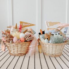 two baskets filled with toys sitting on top of a table