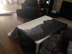 a living room filled with furniture and a flat screen tv sitting on top of a hard wood floor