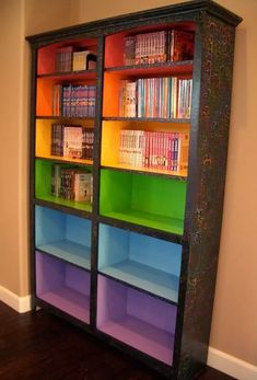 an old bookcase is painted with multicolored books