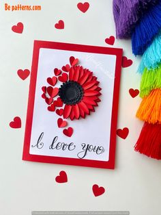 a card that has hearts and a flower on it with the words i love you