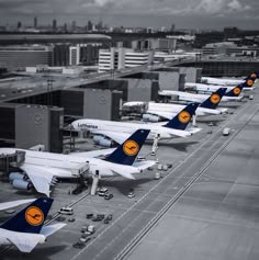 several airplanes are lined up on the tarmac at an airport in black and white