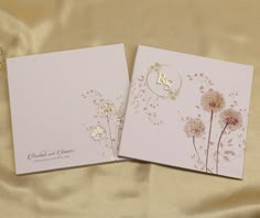 two wedding cards with the letter b on them and dandelions in gold foil