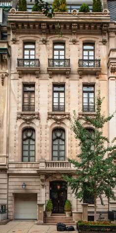 an old building with a tree in front of it