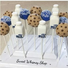 chocolate chip cookies and milk bottles on toothpicks with blue sprinkles