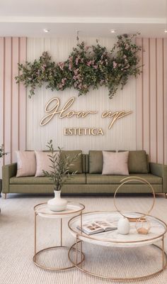 a living room filled with furniture and flowers on the wall next to a coffee table