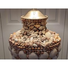 a large stack of seashells with a gold dome on top, sitting in front of a door