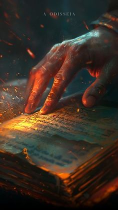 a person's hand on top of a book with fire coming out of it