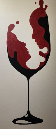 a painting of a woman's face in a glass of red wine on a white wall