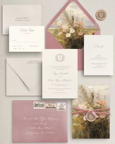 the wedding stationery is laid out on top of each other, with pink envelopes and