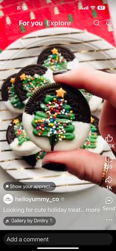 someone is holding their cell phone to take a photo of some cookies on a plate