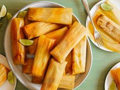 plates of tamales with lime wedges on the side