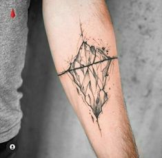 a man's arm with a tattoo on it that has an image of a diamond