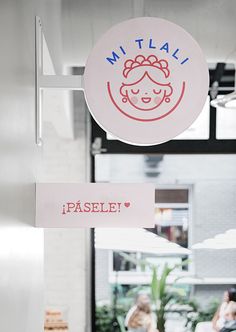 a sign hanging from the side of a building that says pastelle and miai