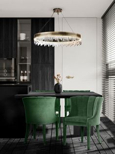 a dining room table with green chairs and a chandelier