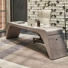 an office desk with a chair and lamp in front of a wall made out of glass blocks