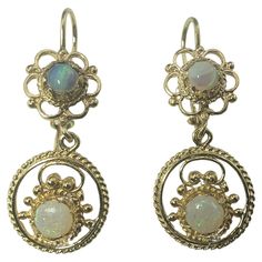 14 Karat Yellow Gold and Opal Dangle Earrings- These elegant dangle earrings each feature two round opals (5 mm and 6 mm) set in beautifully detailed 14K yellow gold. Size: 27 mm x 13 mm Weight: 3.2 dwt. / 5.0 gr. Stamped: 14K Very good condition, professionally polished. Will come packaged in a gift box or pouch (when possible) and will be shipped U.S. Priority Mail Insured. DV052322/17KCS Peregrine Falcon, Thoroughbred, Royce, Knights, Priority Mail, Jewelry Earrings Dangle, Opal, Dangle Earrings, Jewelry Earrings