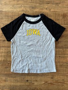 This Iowa Block Baseball Crop Tee is perfect for showing your team spirit. It's made from lightweight cotton-blend fabric and features a crop length, along with raglan sleeves and baby ribbed details. Show off your style and support your favorite team. Relaxed Fit Cropped Cotton T-shirt For Sports, Game Day Cotton Baseball Jersey With Team Logo, College Team-colored Cotton Baseball Jersey, College Baseball Jersey In Team Colors, Casual Raglan Sleeve T-shirt For College, Collegiate Cotton Baseball Jersey With Short Sleeves, Collegiate Short Sleeve Cotton Baseball Jersey, Collegiate Cotton Short Sleeve Baseball Jersey, Team-colored Cotton Baseball Jersey For Sports Season