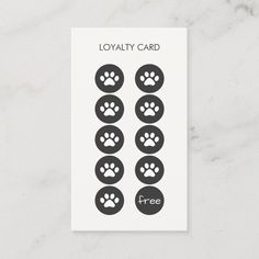 a white card with black paw prints and the words royaltyly card free on it