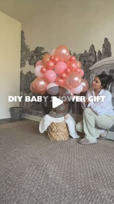 a woman sitting on the floor with balloons in front of her