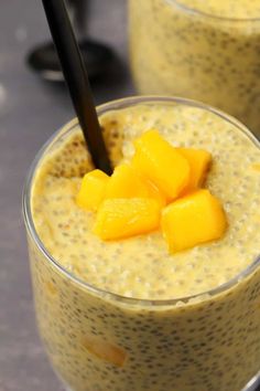 two glasses filled with chia pudding topped with mango slices