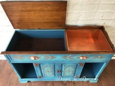 an old dresser painted in blue and gold with ornate designs on the doors, drawers and top