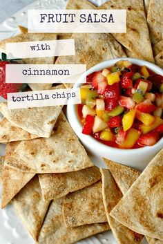 fruit salsa with cinnamon tortilla chips on a white plate and text overlay reads, fruit salsa with cinnamon tortilla chips