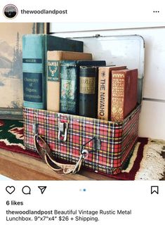 an old suitcase filled with books on top of a rug next to a window sill