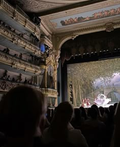 an audience is watching a performance on stage