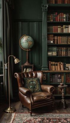 a chair in front of a bookshelf with a globe on top of it