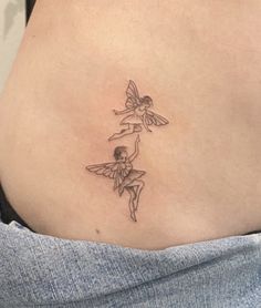 a woman with a tattoo on her stomach has two small fairy tinkerbells