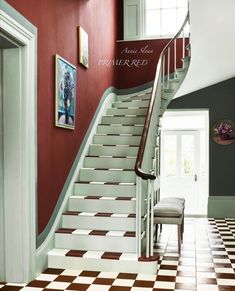 the stairs are painted red and white with checkered flooring