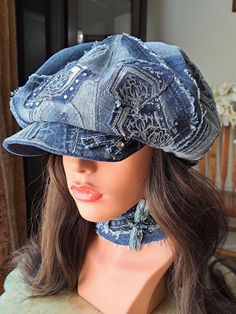 a mannequin's head wearing a denim hat with an intricate design on it