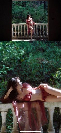 a woman laying on top of a white bench