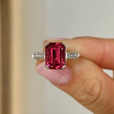 Three Stone Wedding Ring, Pink Garnet Emerald Gemstone Ring, East To West Baguette Shape Engagement Ring, 925 Silver Ring, Prong Set Ring Item Description: Stone - Simulated Diamond Shape- Emerald Cut Stone - Simulated Diamond Shape- Baguette Cut 1. White Gold: 10K/14K/18K 2. Yellow Gold: 10K/14K/18K 3. Rose Gold: 10K/14K/18K 4. Silver: Sterling Silver 925 Size Customization: What Size you want... * You can also Customize ring size in US 4 to US 12! It sometimes affects to price. * Main Stone & Shape Customization: Main Stone: Cubic Zirconia, Moissanite, Natural Diamond, CVD Diamond Shape Choice: Round Cut, Heart, Princess Cut, Pear Cut, Cushion Cut, Marquise, Oval Shape, Asscher, Emerald, Radiant, Old European Cut, Old Mine Cut * Check out Special Notes: At checkout, leave us a note in th Luxury Ruby Rectangular Rings, Elegant Luxury Baguette-cut Ruby Ring, Luxury Baguette Cut Ruby Ring, Wedding Ring Pink, Ruby Ring Silver, Three Stone Wedding Ring, Stone Wedding Ring, Pink Garnet, January Birthstone Rings