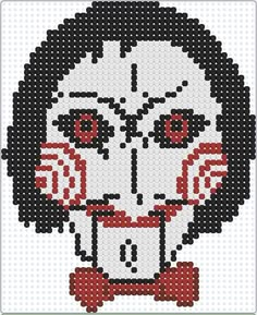 an image of a cross stitch skull with red eyes