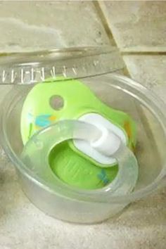 a baby bottle in a plastic container on the floor