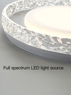 a round light fixture with crystal glass on the top and bottom, surrounded by text that reads full spectum led light source