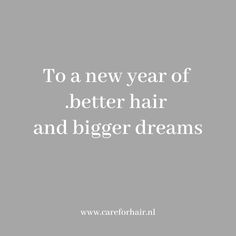 the words to a new year of better hair and bigger dreams are in white on a gray background