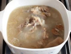 a pot filled with soup sitting on top of a stove