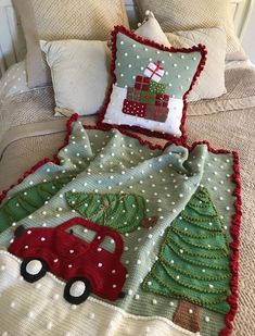 a red truck with a christmas tree on it is sitting in front of a pillow