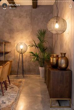 a living room filled with lots of furniture and plants on top of a wooden table