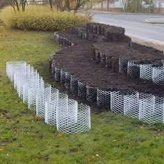 there are many pipes that have been dug into the ground to be used as plant markers