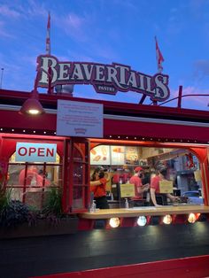 a restaurant called beavertails with the sign above it's door and people standing outside