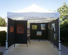 a white tent with black walls and pictures on it