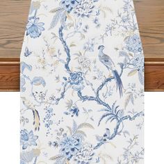 a blue and white table cloth with birds on it