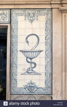 an ornate blue and white tile mural on the side of a building with a fountain